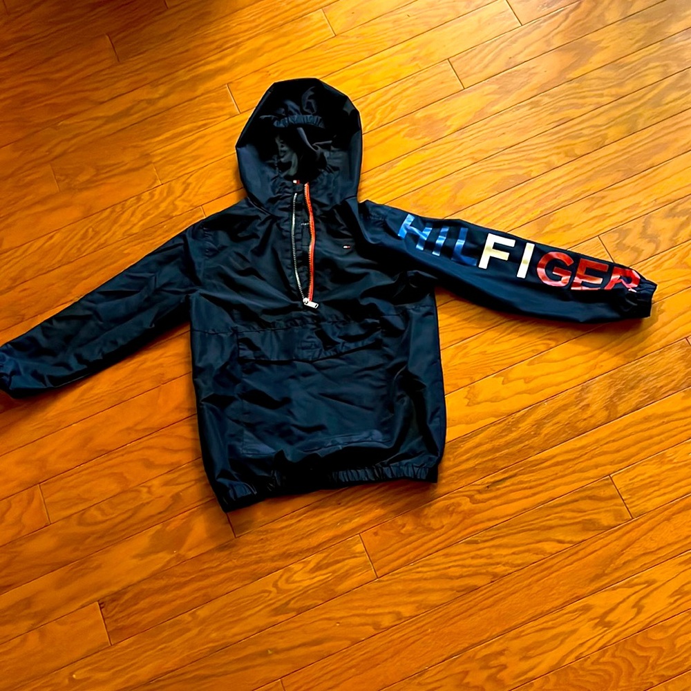 A jacket that says he’ll figure on the sleeve and it is dark blue white and red.